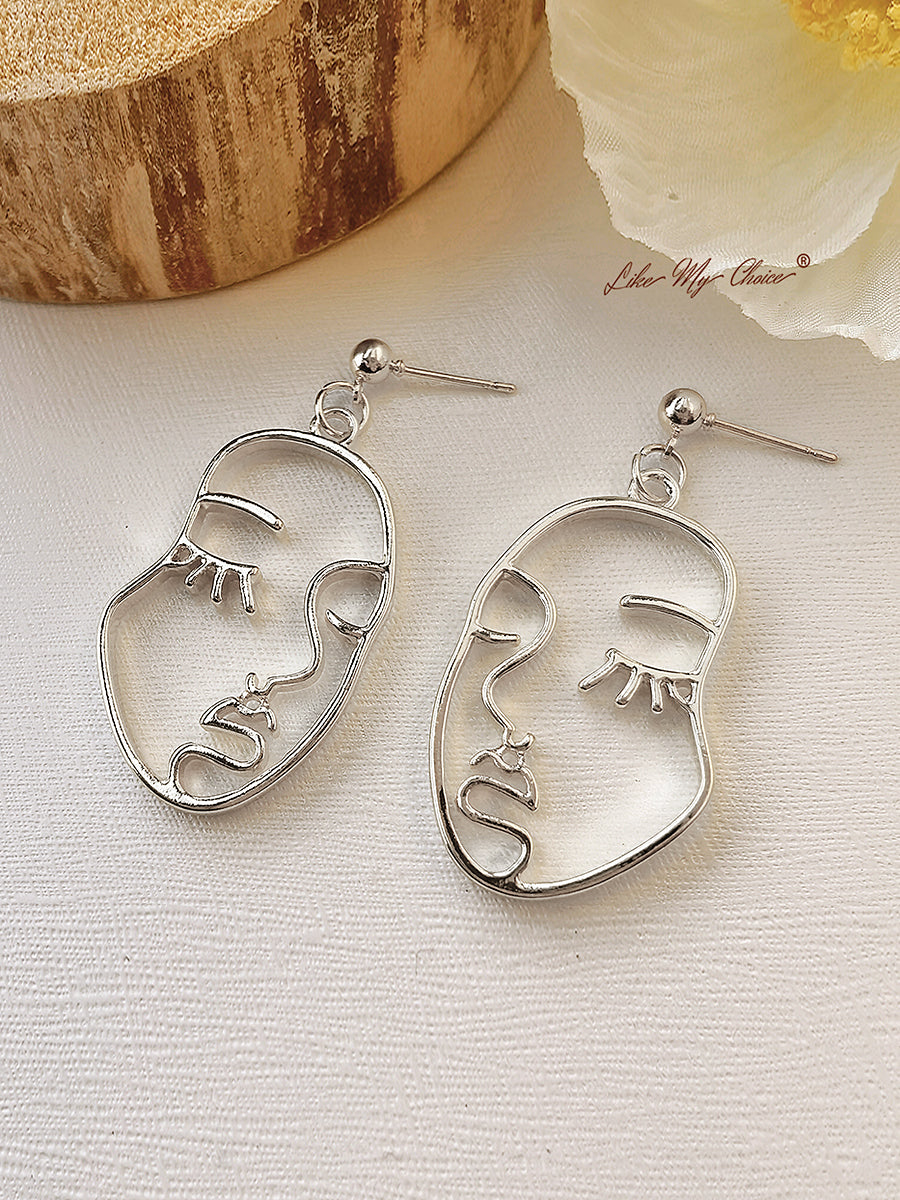 Boucles d'oreilles pampilles visage humain abstrait