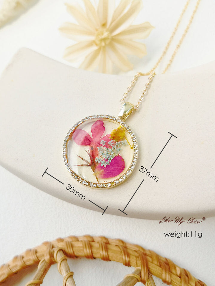 Collier avec pendentif en cristal rond et fleur d'orchidée dansante en résine