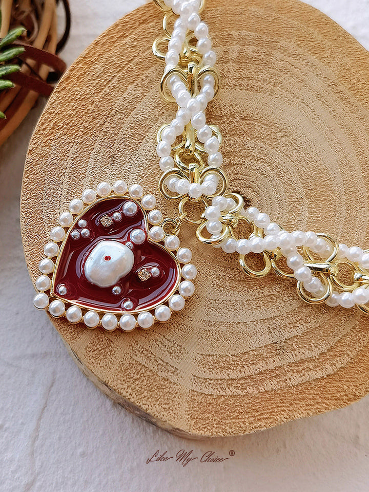 Collier de perles tressées et d'émaux en forme de coeur rouge